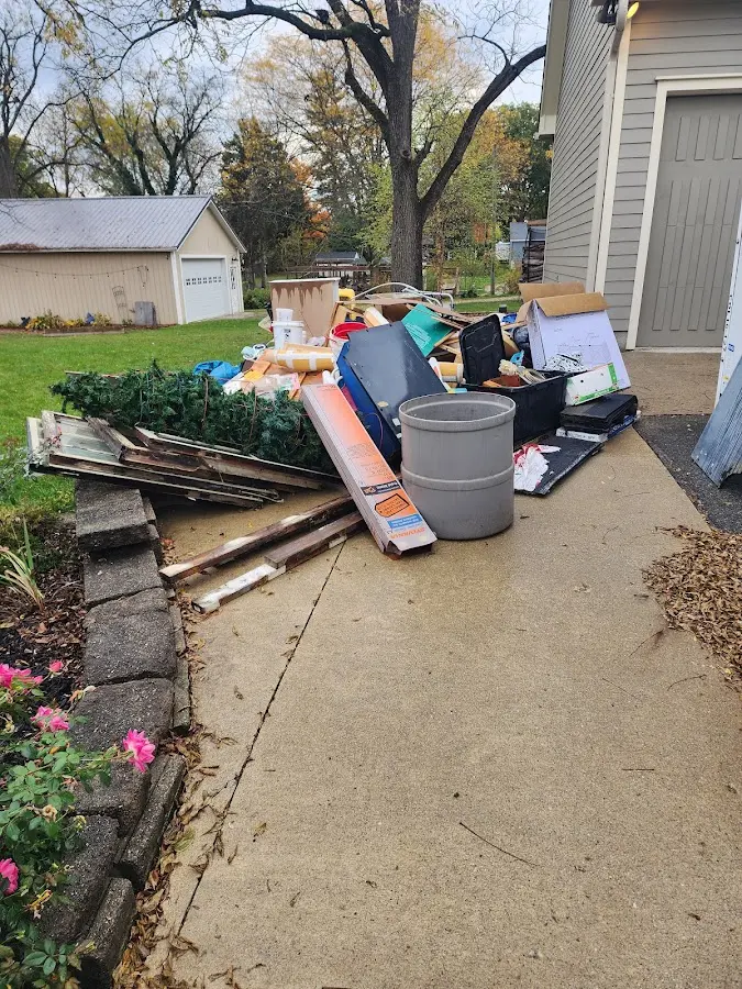 Dumpster being loaded with debris for Commercial Dumpster Rental in North Hobbs